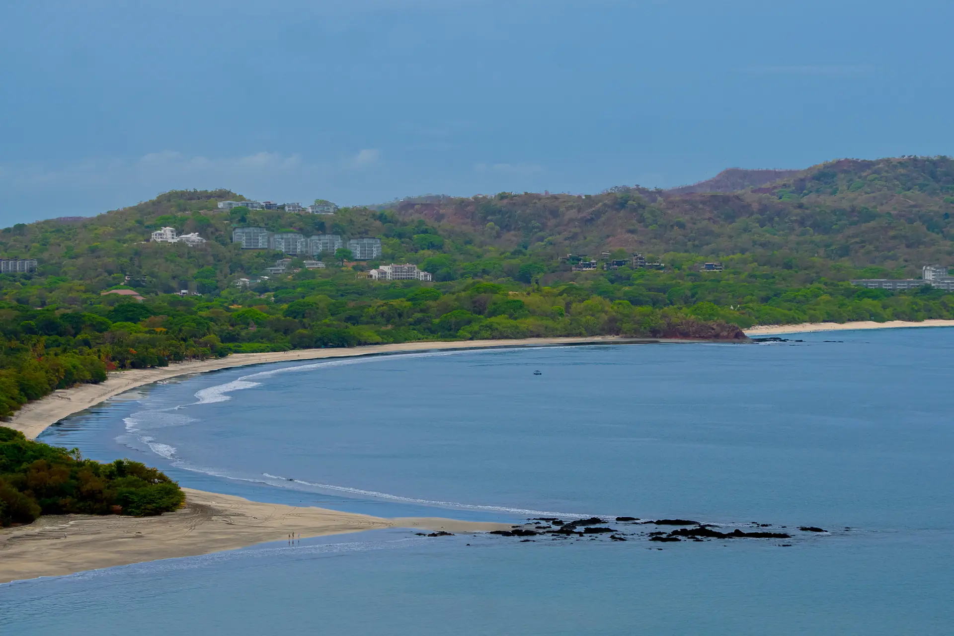 Calm curved bay with green hills on Guanacaste's Gold Coast